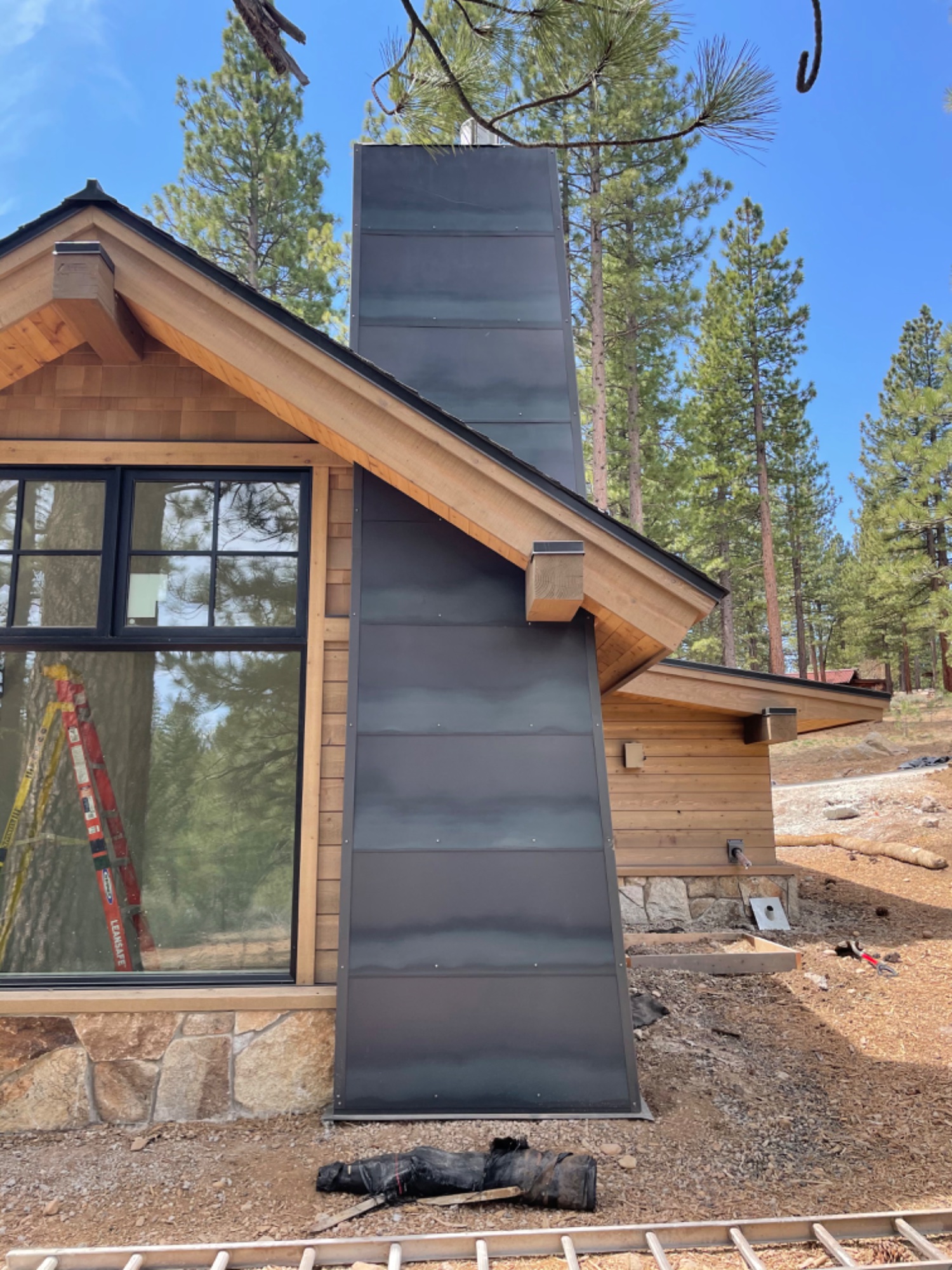 Metal chimney chase installed on mountain home