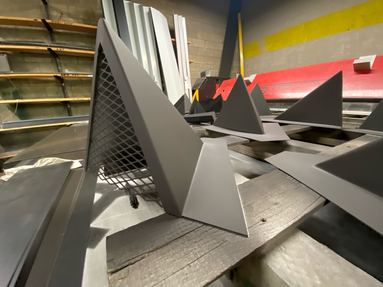 Custom painted chimney caps in the Pro Form Metals shop