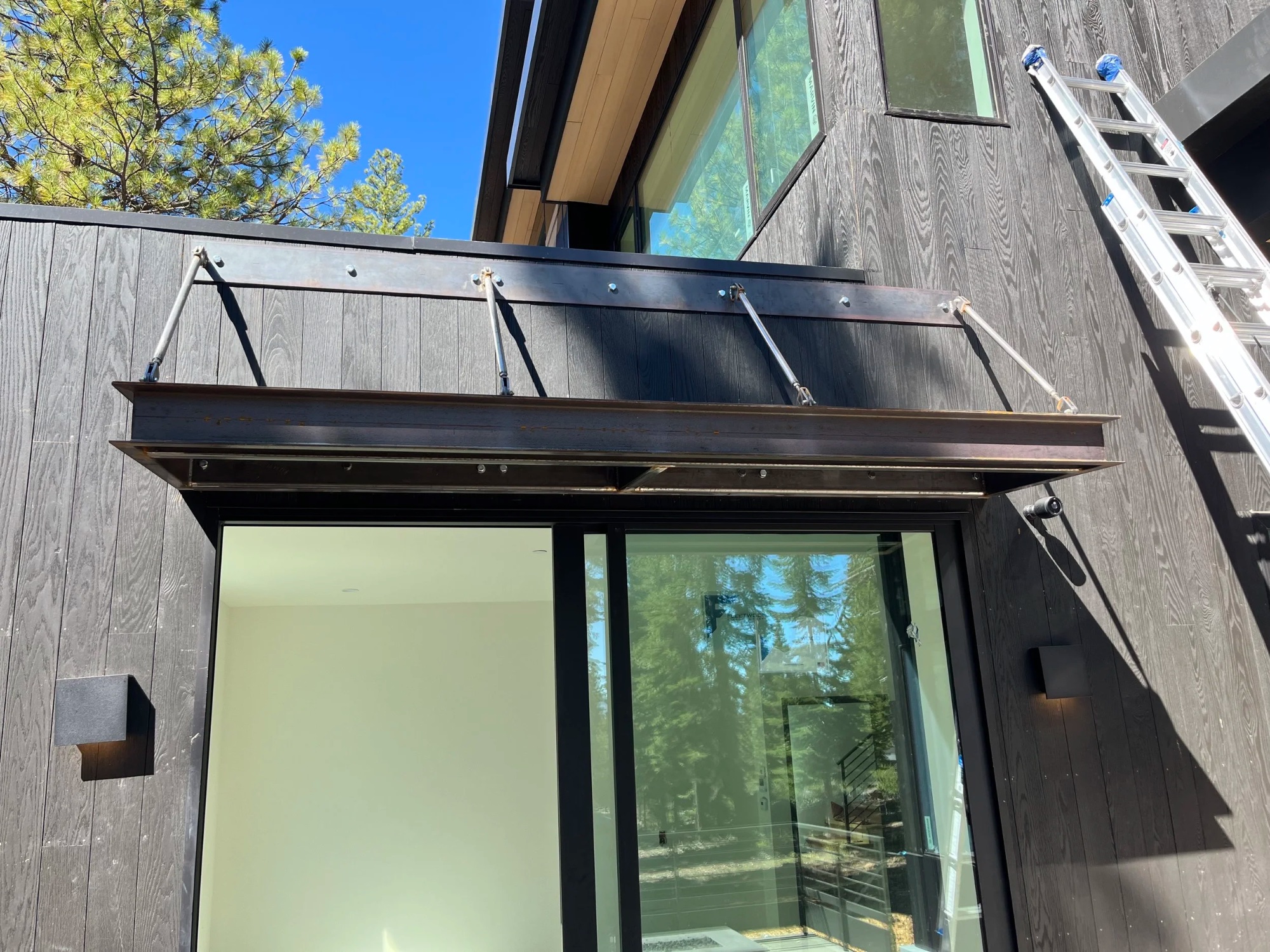 Custom metal awning with turnbuckle supports